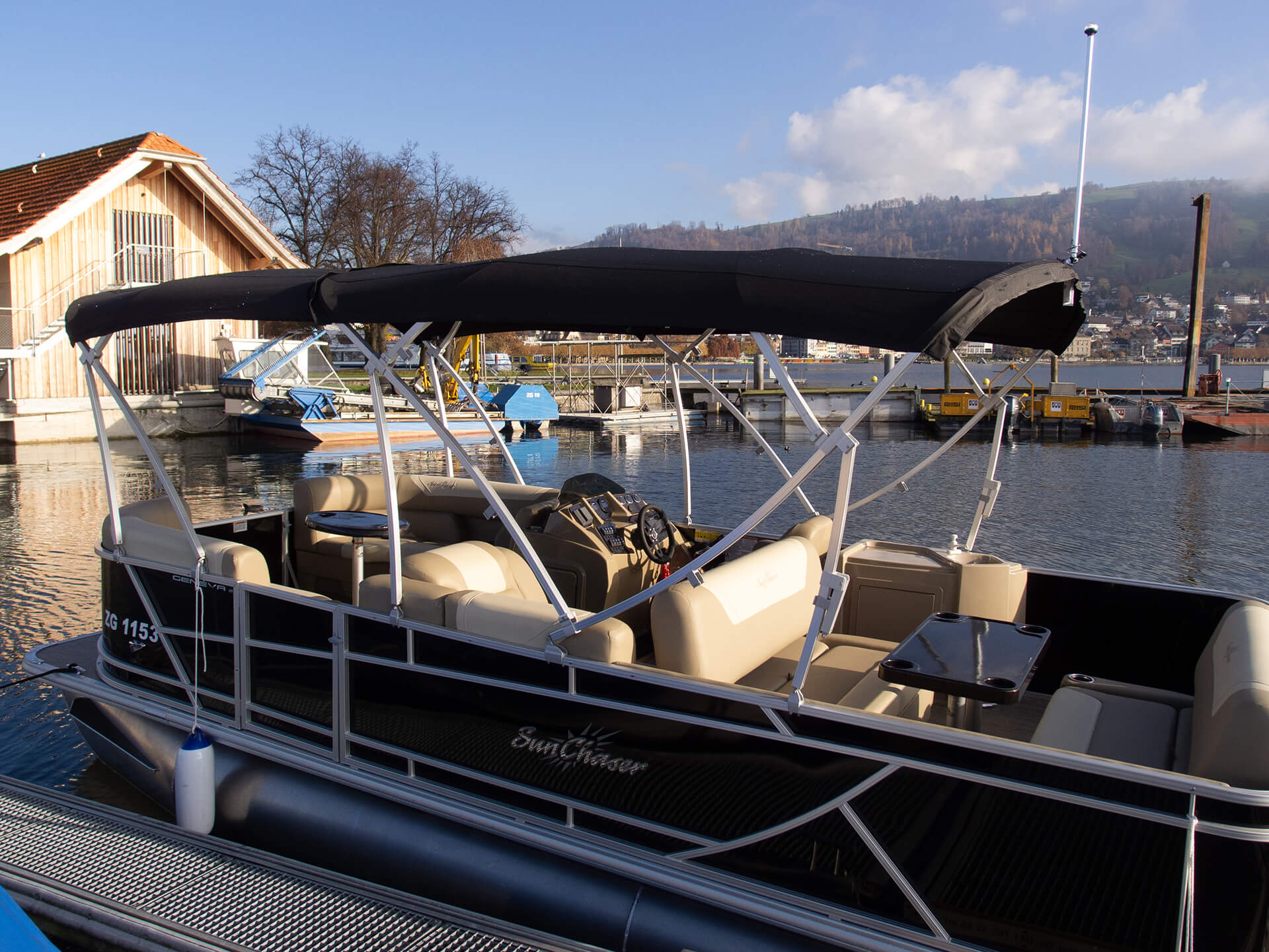 Side shot of a black boat tied on a port