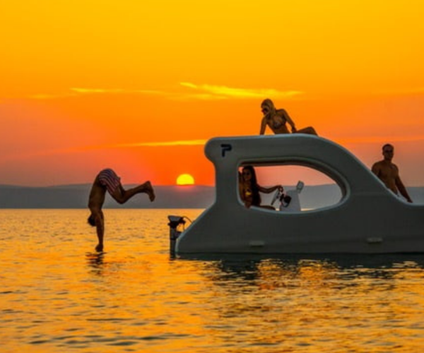 A group of friends having fun in Lake Zug on a white boat called E-Trinity 1