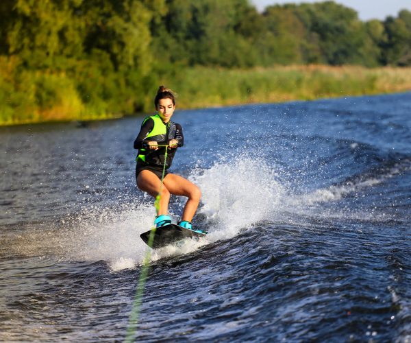 A young woman paddle boarding